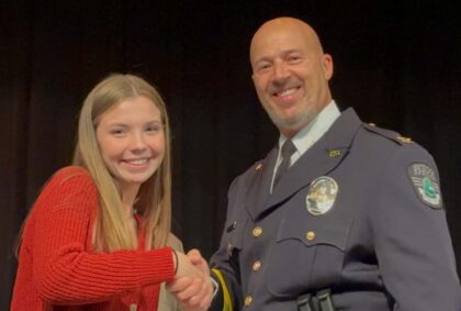 Teen Ava Donegan is recognized by Excelsior Springs Police Department Chief Gregory Dull in an Awards Ceremony with the Clay County Sheriff's Department.